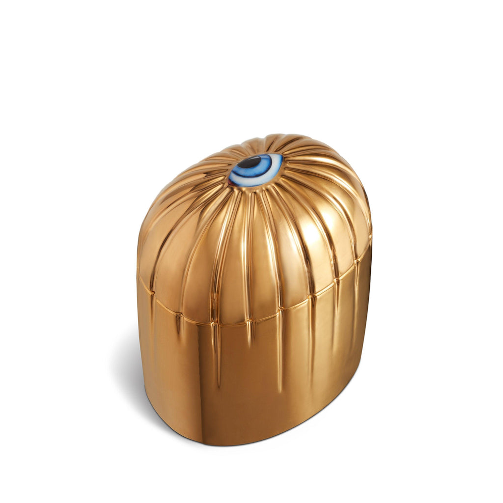 Gold cylinder candle with details dripping from top eye motif